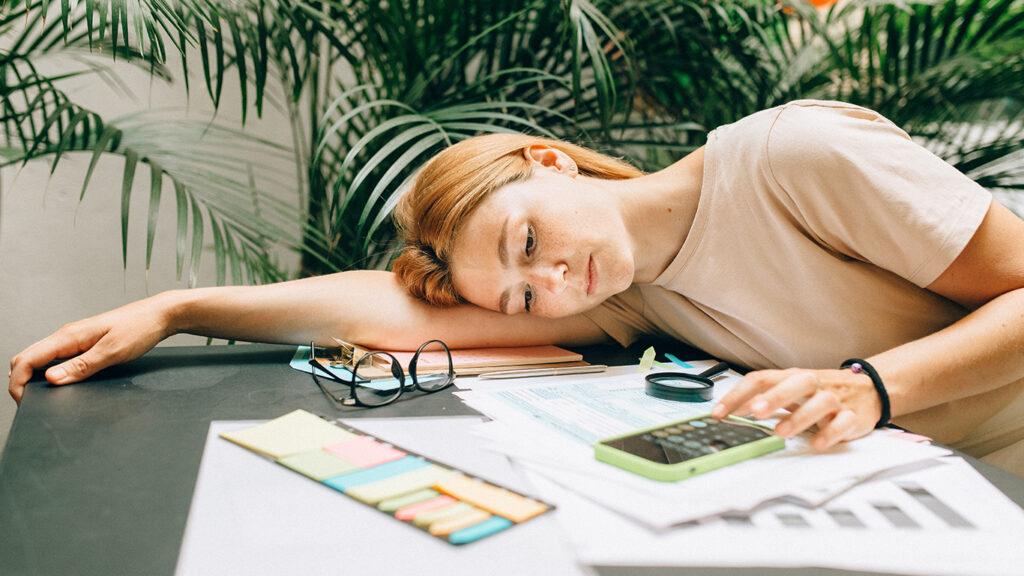 A Woman using a Calculator using Smartphone