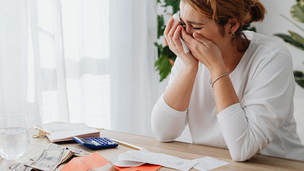 Woman Crying while Sitting Behind a Desk