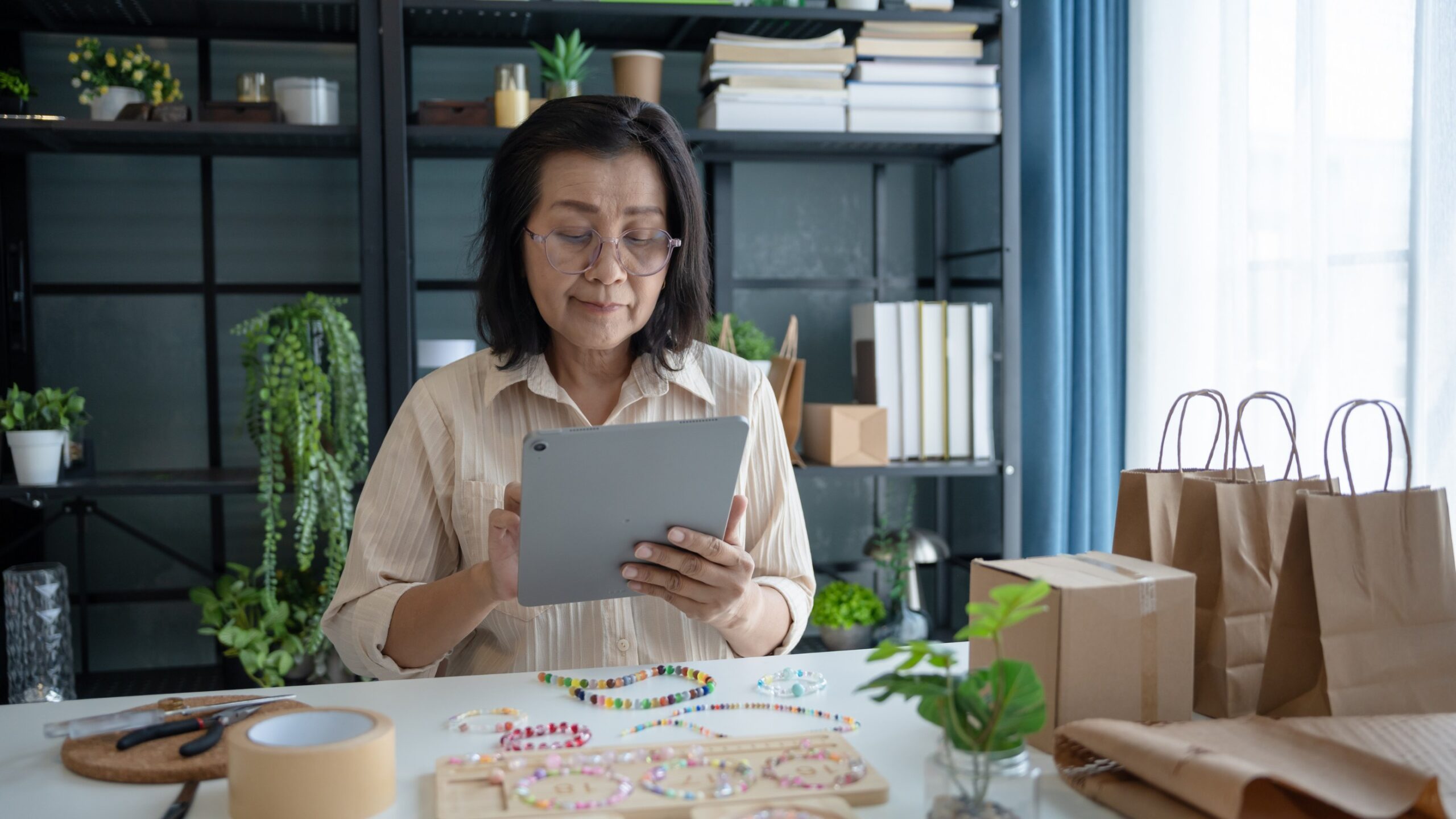 Lady sitting at desk on ipad