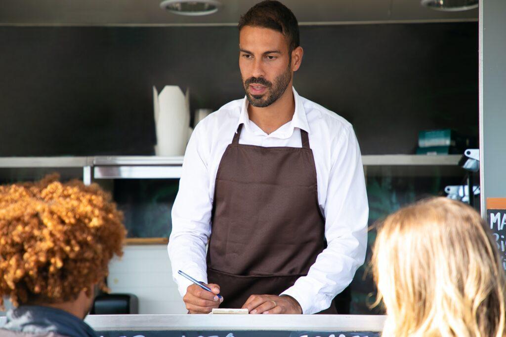 small business owner taking orders food truck