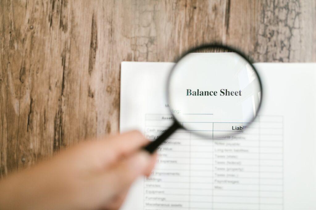 magnifying glass on balance sheet